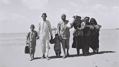 A Yemenite family walks through the desert to a reception camp set up by the American Jewish Joint Distribution Committee near Aden. Nov. 1, 1949. Credit: Zoltan Kluger/Wikimedia Commons.