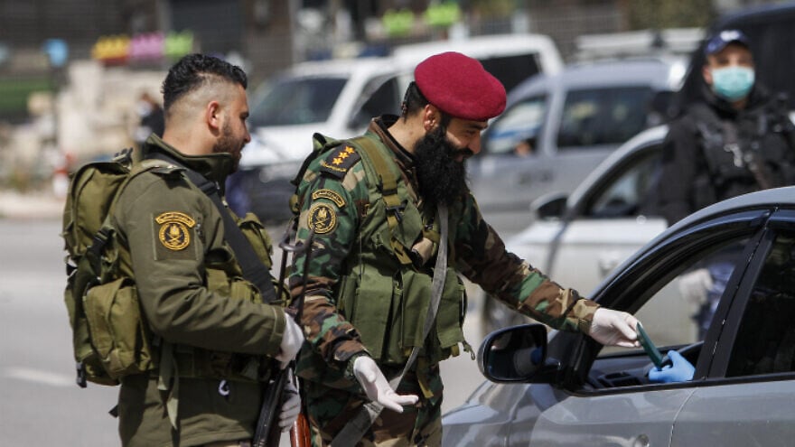 Palestinian security personnel  block the entrance to the Samarian city of Nablus (Shechem), March 23, 2020. Photo by Nasser Ishtayeh/Flash90.
