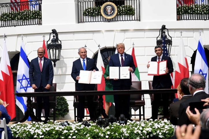 Israeli Prime Minister Benjamin Netanyahu, U.S. President Donald Trump, UAE Foreign Minister Abdullah bin Zayed Al Nahyan and Bahraini Foreign Minister Abdullatif bin Rashid Al Zayani hold up the Abraham Accords, during the signing ceremony at the White House, Sept. 15, 2020. Photo by Avi Ohayon/GPO.