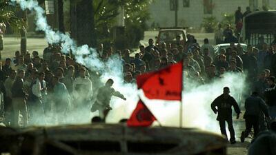 Palestinians shoot tear gas at the Israeli army in Ramallah as they clash during the early days of the Second Intifada, or “uprising,” a period of intensified violence that began in September 2000 and lasted five years. Photo by Nati Shohat/Flash90.