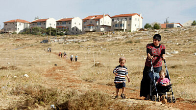 A woman and her children walk toward Kochav Hashachar in the Binyamin of Samaria on June 4, 2009. Photo by Abir Sultan/Flash90.