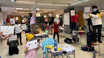 Students at the Ramaz School in New York City show off the ‘Sensory Chanukah Cards’ they created to brighten the holiday for ADI’s residents with severe disabilities.