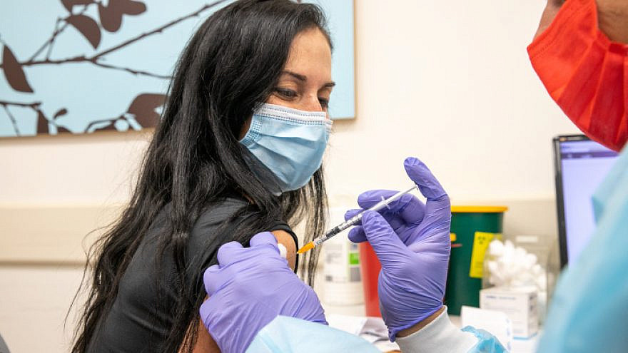 An employee in Israel's education field receives a COVID-19 vaccine injectionon on Jan. 12, 2021. Photo by Yossi Aloni/Flash90.