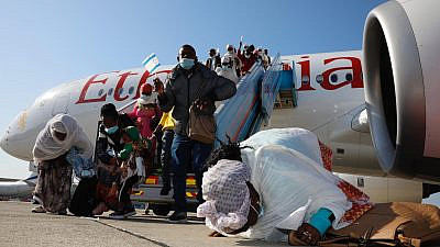 Ethiopian immigrants to Israel, part of “Operation Tzur Israel” (“Rock of Israel”), after exiting the plane at Ben-Gurion International Airport on Dec. 3, 2020. Credit: Olivier Fitoussi/The Jewish Agency for Israel.