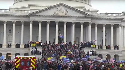 Supporters of President Donald Trump at the U.S. Capitol, where hundreds smashed windows and broke into the building while protesting the results of the November elections, Jan. 6, 2021. Source: YouTube.