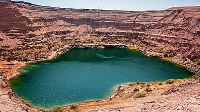 The hidden lake at Timna in the desert was formed when copper quarries were flooded. Credit: Gur Tatiana via Shutterstock.com.