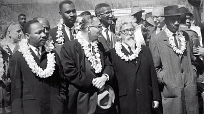 From the documentary film “Spiritual Audacity: The Abraham Joshua Heschel Story,” Rabbi Heschel (second from right) is seen marching with Martin Luther King Jr. and other black civil-rights leaders in Selma, Ala., on March 7, 1965. Source: Screenshot.