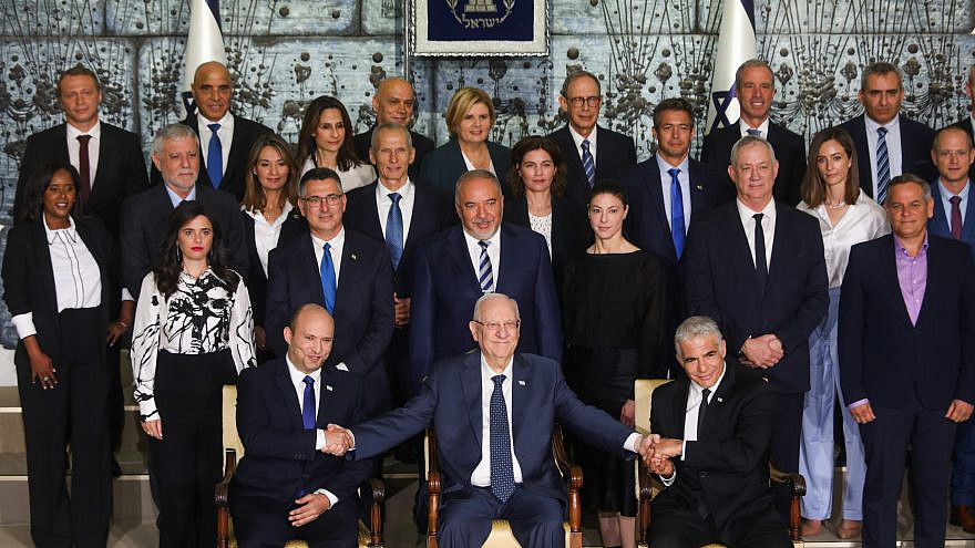 Israeli Prime Minister Naftali Bennett (front row, left), Israeli President Reuven Rivlin, Israeli Foreign Minister Yair Lapid (front row, right) and Israeli ministers pose for a group photo of the newly sworn-in Israeli government, at the President's Residence in Jerusalem on June 14, 2021. Photo by Yonatan Sindel/Flash90.