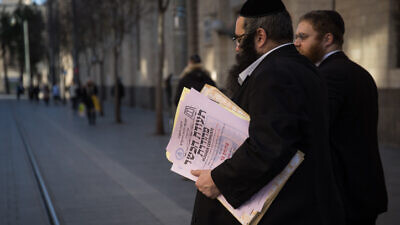 Representatives of the Chief Rabbinate of Israel deliver a kashrut certificate to a local restaurant, in central Jerusalem, on Dec. 31, 2019. Photo by Hadas Parush/Flash90.