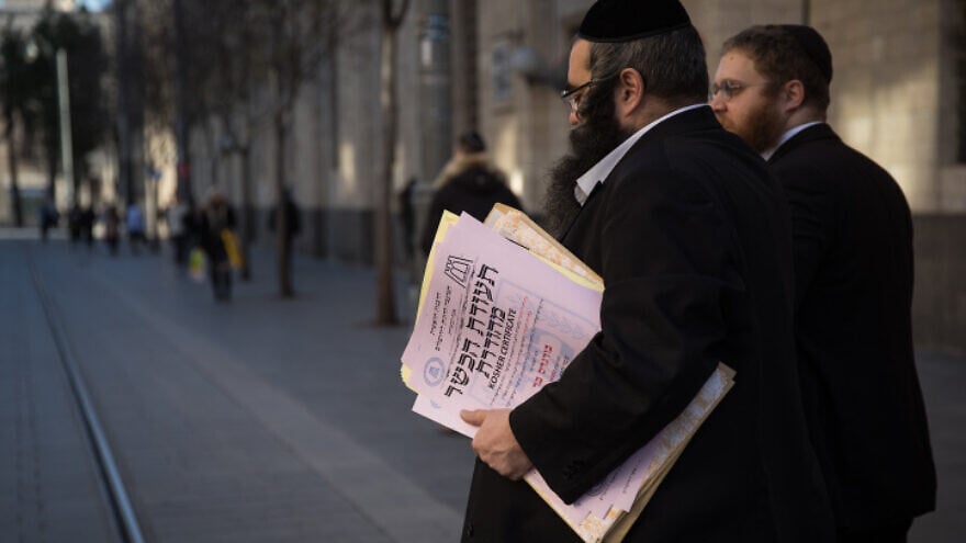 Representatives of the Chief Rabbinate of Israel deliver a kashrut certificate to a local restaurant, in central Jerusalem, on Dec. 31, 2019. Photo by Hadas Parush/Flash90.