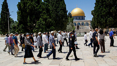 Israeli security forces escort a group of religious Jews as they visit the Temple Mount in Jerusalem's Old City, after it was reopened to the public, May 31, 2020. Photo by Sliman Khader/Flash90.