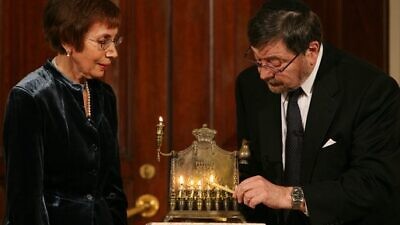 A menorah belonging to the great-grandfather of Daniel Pearl is lit by Judea and Ruth Pearl, his parents, at a Hanukkah celebration on Dec. 10, 2007, in the Grand Foyer of the White House in Washington, D.C. Credit: White House Photo by Joyce N. Boghosian.