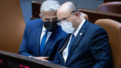 Israeli Foreign Affairs Minister Yair Lapid (left) and Israeli Prime Minister Naftali Bennett during a plenum session in the Knesset on Aug. 2, 2021. Photo by Yonatan Sindel/Flash90.