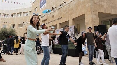 New immigrants to Israel dance the hora in Jerusalem. Credit: Zug Productions for the Jewish Agency.