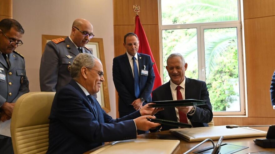 Israeli Defense Minister Benny Gantz (right) signs a memorandum of understanding with his counterpart, Moroccan Minister Delegate to the Head of Government in Charge of National Defense Abdellatif Loudiyi, Nov. 24, 2021. Credit: Ariel Hermoni/Israeli Defense Ministry.