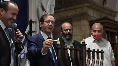 Israeli President Isaac Herzog lights a menorah inside of the Cave of the Patriarchs in the city of Hebron, Nov. 28, 2021. Credit: Koby Gideon/GPO.