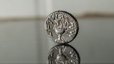A 2,000-year-old silver coin found in debris from an excavation in the City of David, Jerusalem. The inscription reads, "Shekel Yisrael." Above the chalice are the Hebrew letters "shin" and "bet," an acronym for "Shana Bet," or year two of the Jewish revolt against Rome. Credit: Eliyahu Yanai/City of David.