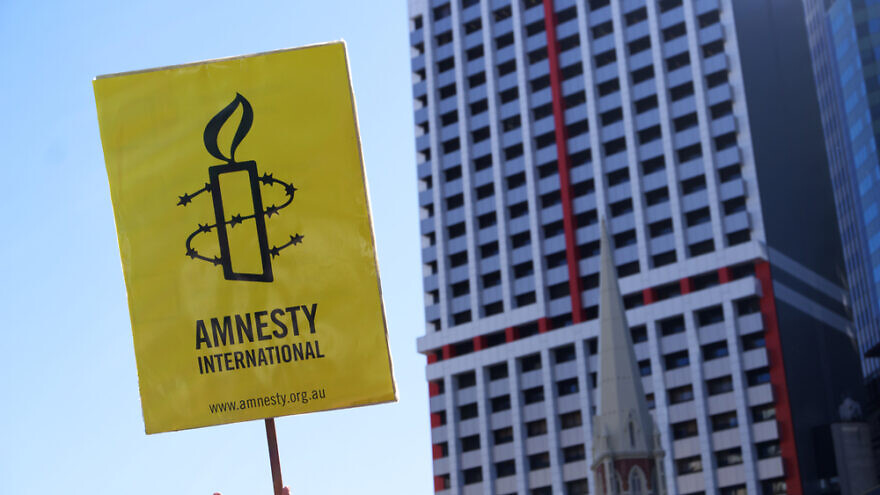 A sign displaying the logo of Amnesty International. Credit: Paintings/Shutterstock.