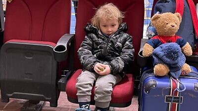 A Ukrainian child waits for a place to stay at a refugee center in Moldova, March 2022. Credit: Courtesy.