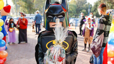 Kids dressed up in costumes arrive at their school ahead of the Jewish holiday of Purim in Sderot, southern Israel on  Feb. 24, 2021. Photo by Flash90.