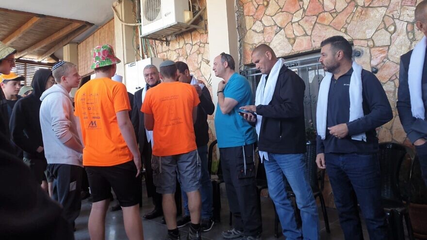 Students from the Derech Avot High School of the Ohr Torah Stone educational network in Efrat visit the family of a Druze police officer, 19-year-old Yazan Falah, who was killed in a terrorist attack in Hadera on March 27, 2022. Credit: Courtesy of Ohr Torah Stone.