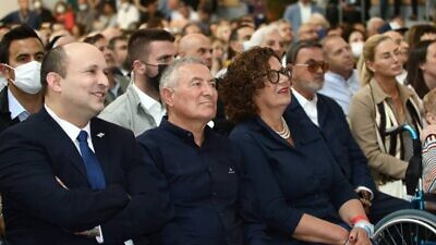 Didi and Maj. Gen. (Res.) Doron Almog, founders of ADI Negev-Nahalat Eran, and Israeli Prime Minister Naftali Bennett listen as guest of honor Gloria Kaylie addresses the crowd at the grand opening of the Harvey and Gloria Kaylie Rehabilitation Medical Center on April 12, 2022. Credit: ADI.