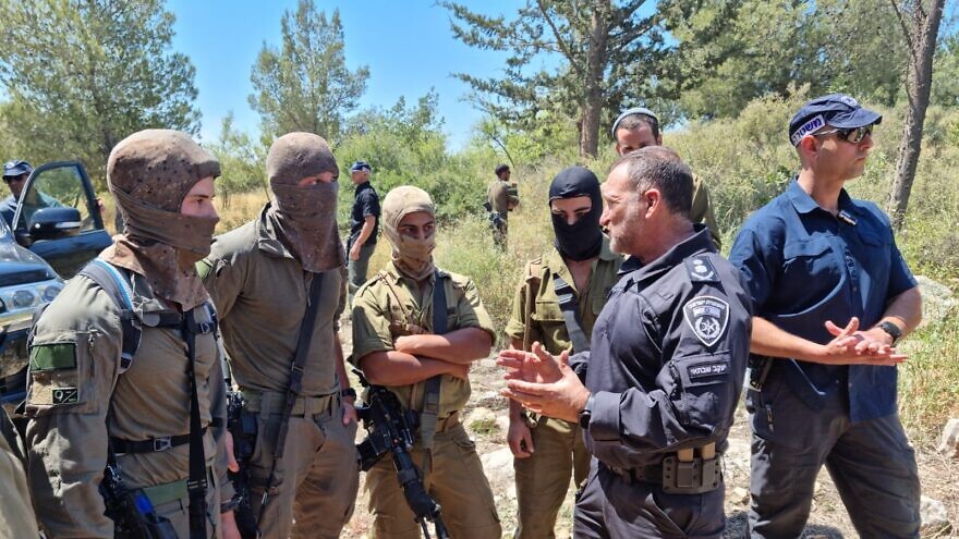 Israel Police Commissioner Yaakov Shabtai (second from right) talks with members of the Israeli forces participating in the search for the terrorists who murdered three people in the city of Elad on May 5, 2022, in this image posted on social media on May 8, 2022. Source: Israel Police Twitter.
