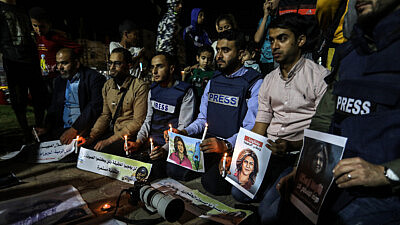 Palestinian journalists take part in a candlelight vigil in the Gaza Strip in memory of Al-Jazeera journalist Shireen Abu Akleh, who was killed during a raid of Israeli security forces in the West Bank city of Jenin on May 11, 2022. Photo by Abed Rahim Khatib/Flash90.