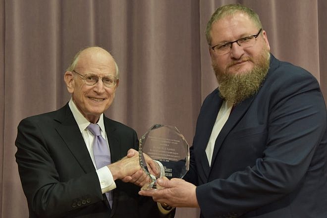 Stuart E. Eizenstat, chairman of the United States Holocaust Memorial Council, presents historian Piotr Cywiński, director of the Auschwitz-Birkenau State Museum, with the National Leadership Award on the site’s 75th year, July 13, 2022. Photo by Photo by Łukasz Lipiński.