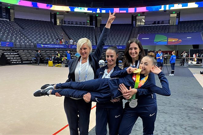 Daria Atamanov (being held) celebrates her medals in rhythmic gymnastics. Photo by Larry Brook.