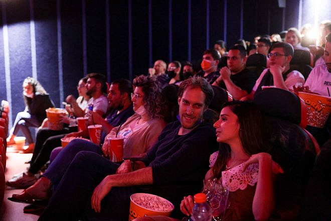 Israelis attend a movie at the Cinema City theater on the official reopening night after 14 months of closure during the coronavirus pandemic, on May 27, 2021 in Jerusalem. Photo by Olivier Fitoussi/Flash90.