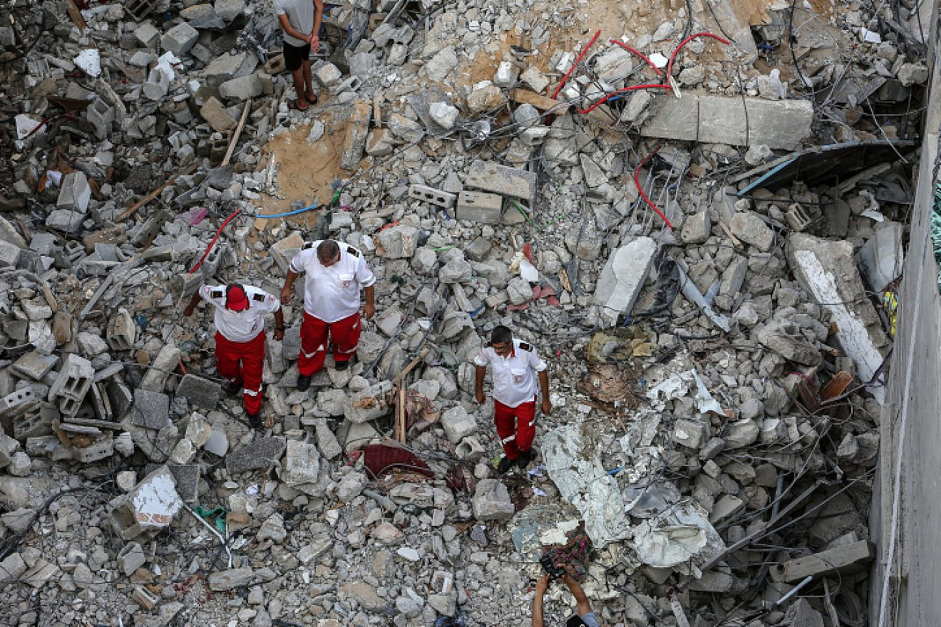 Palestinians gather at the scene where senior Palestinian Islamic Jihad commander Khaled Mansour was killed by an Israeli airstrike, in Rafah in the southern Gaza Strip, on Aug. 7, 2022. Photo by Attia Muhammed/Flash90.