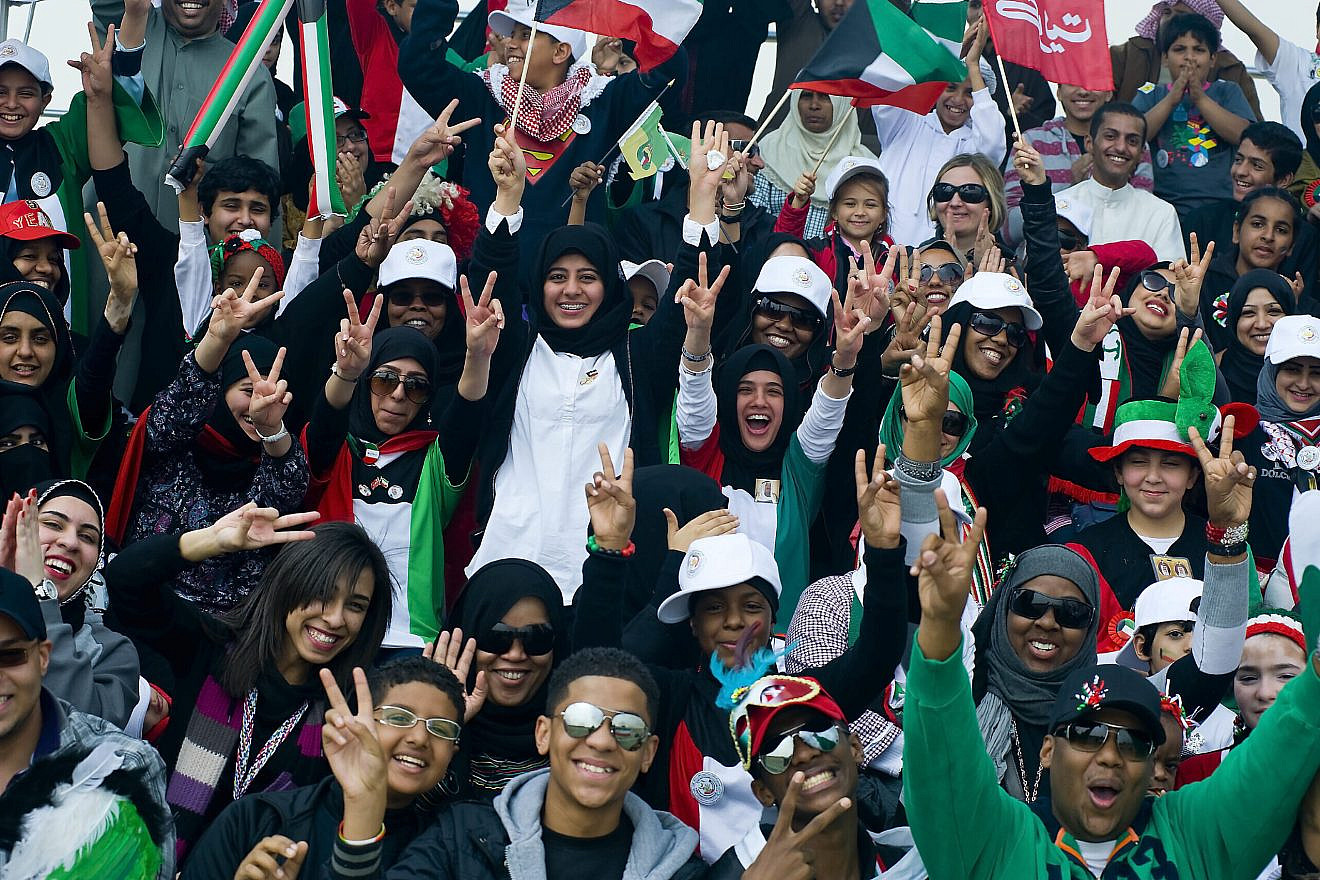 Kuwaiti youth erupt in cheers with a message of peace during the “50/20” celebration parade honoring 50 years of Kuwaiti independence and 20 years since America’s “Operation Desert Storm,” Feb. 26, 2011. Credit: Photo by Spc. Eric Guzman/Third Army/U.S. Army Central PAO via Wikimedia Commons.