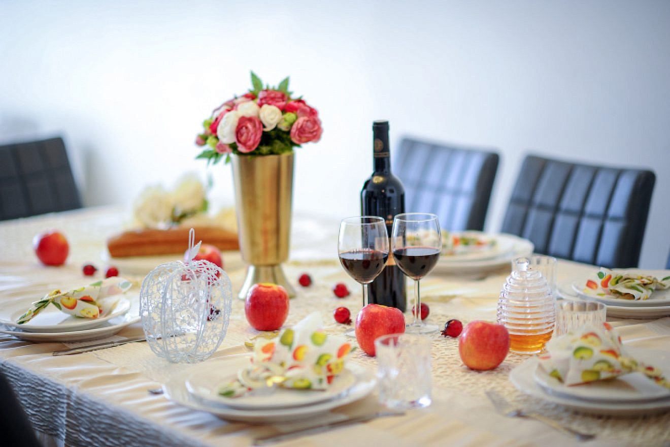 A table set for a traditional Rosh Hashanah meal in Israel, Sept. 10, 2017. Photo by Mendy Hachtman/Flash90.