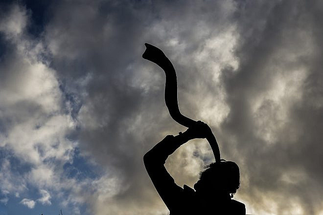 A Jewish man blows a shofar horn in Meron in northern Israel on Dec. 1, 2021. Photo by David Cohen/Flash90.