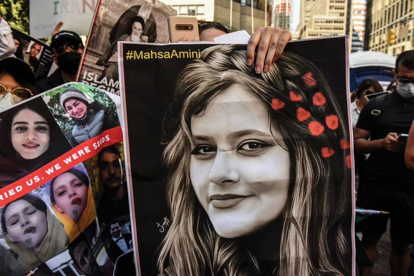 A protester holds a picture of Mahsa Amini, the Kurdish-Iranian woman whose 2022 death in the custody of Iran’s “morality police” sparked widespread unrest in the Islamic Republic. Source: Twitter.