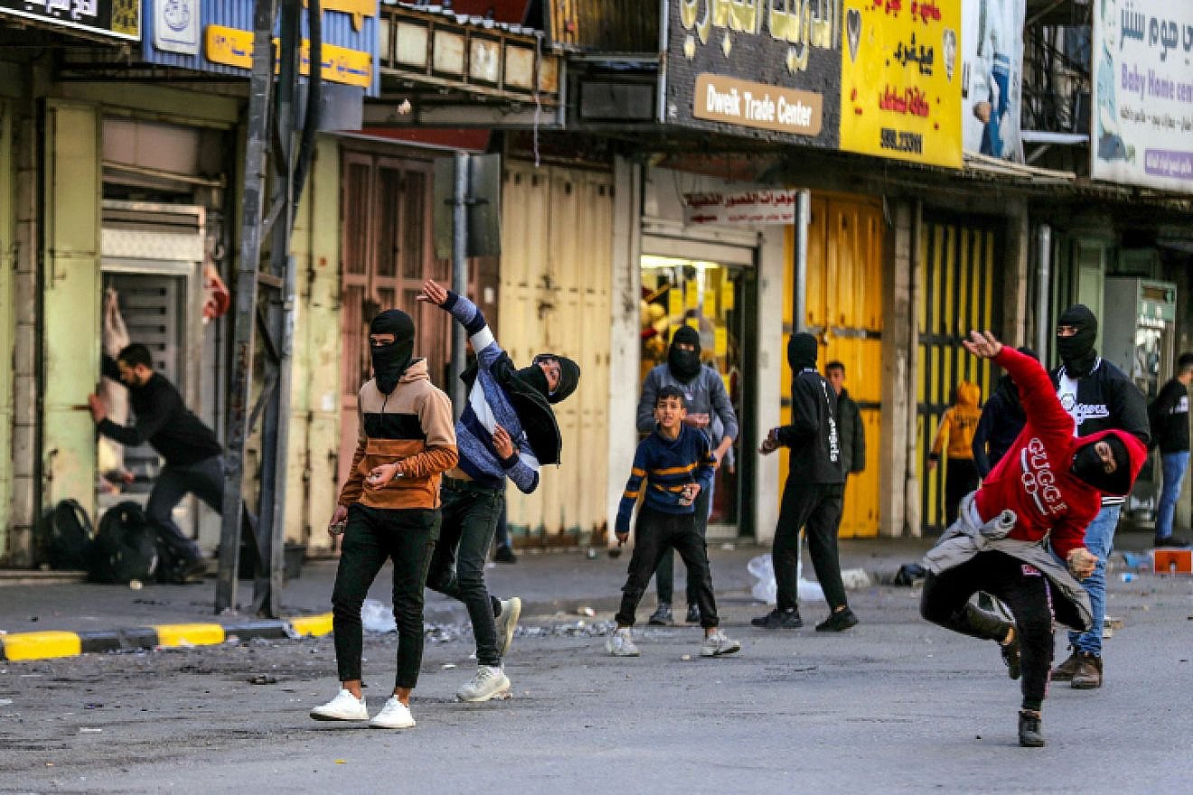 Israeli soldiers clash with Palestinian youth following a military operation in the West Bank city of Jenin on Jan. 26, 2023. Photo by Wisam Hashlamoun/Flash90.