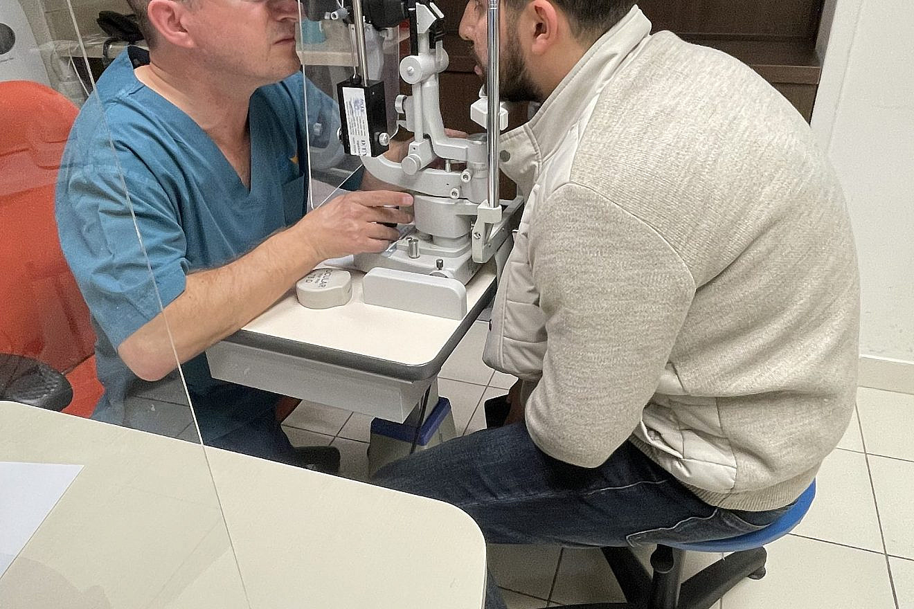 Dr. Yishay Falick examines Arif Hajiyev's cornea transplant at Misgav Ladach hospital in Jerusalem. Credit: Courtesy