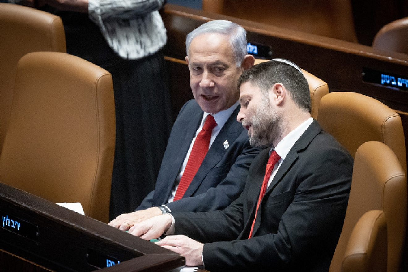 Israeli Prime Minister Benjamin Netanyahu speaks with Israeli Finance Minister Bezalel Smotrich during a discussion and a vote on the government's judicial overhaul plans in the Knesset assembly hall, on Feb. 20, 2023. Photo by Yonatan Sindel/Flash90.