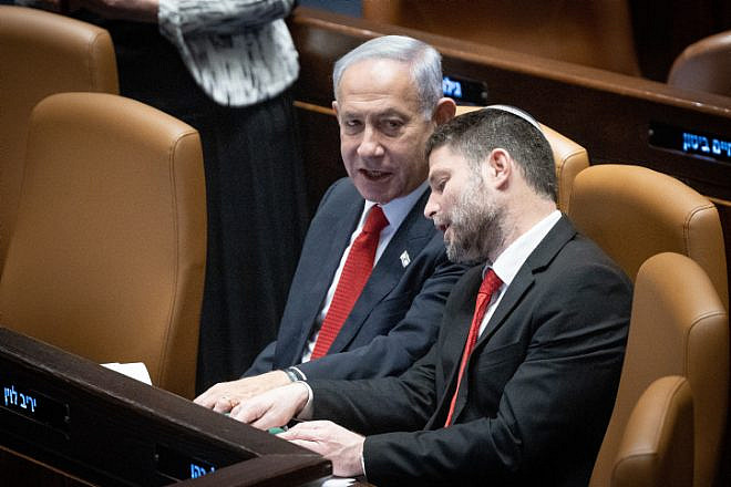 Israeli Prime Minister Benjamin Netanyahu speaks with Israeli Finance Minister Bezalel Smotrich during a discussion and a vote on the government's judicial overhaul plans in the Knesset assembly hall, on Feb. 20, 2023. Photo by Yonatan Sindel/Flash90.