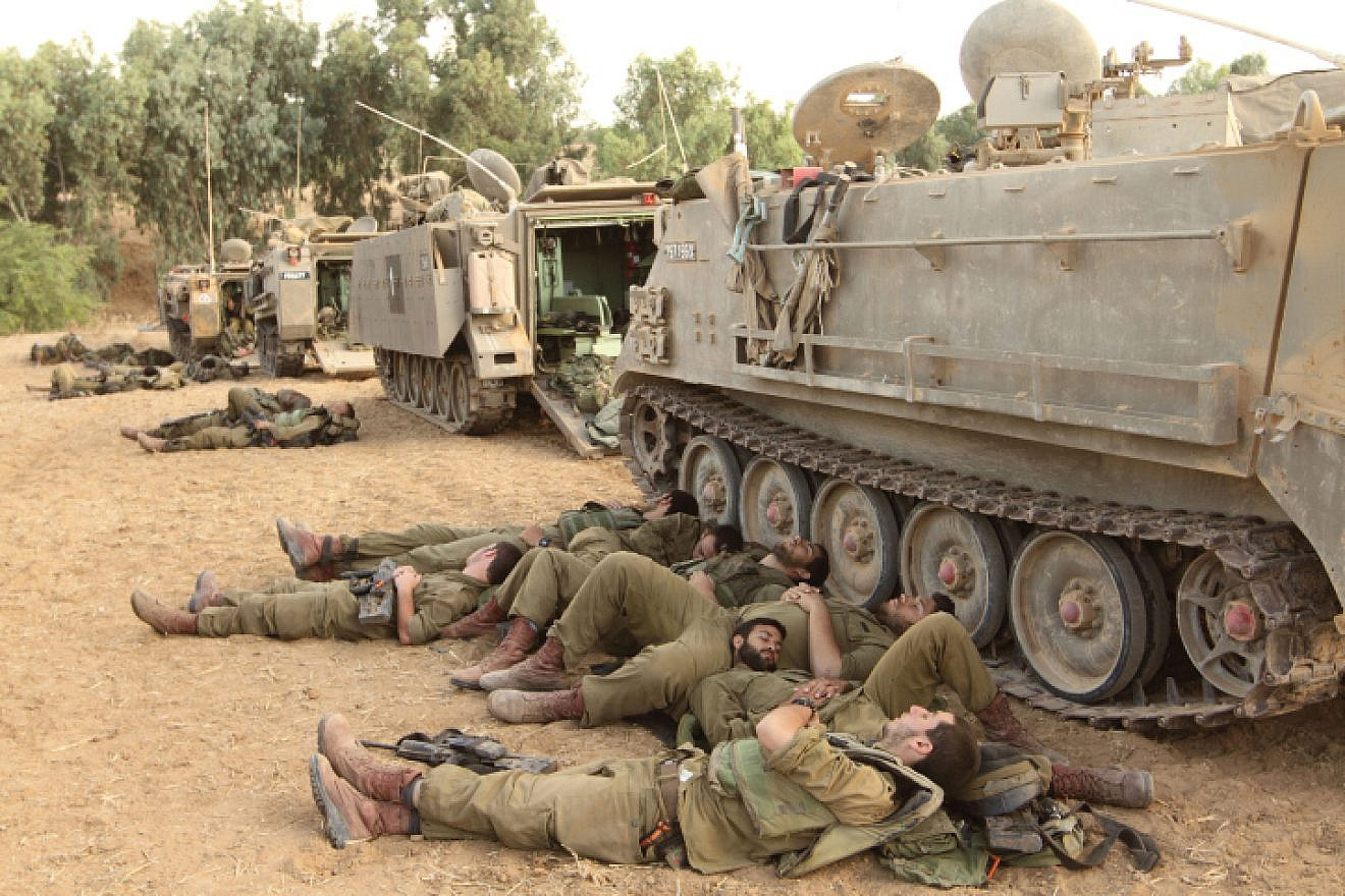IDF reservists sleep near armored personnel carriers at the Gaza border, on the eighth day of “Operation Protective Edge,” July 15, 2014. Photo by Yossi Aloni/Flash90.