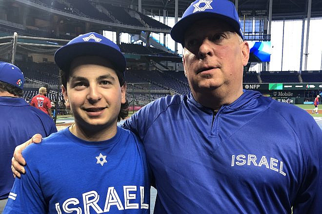 Jordan Gladstone, a batboy for Team Israel, and his father Adam Gladstone, who works in operations for the team, at the World Baseball Classic on March 13, 2023 in Miami. Photo by Howard Blas.