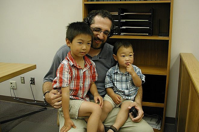 A father and his adopted sons. Photo by Brendon Connelly via Wikimedia Commons.