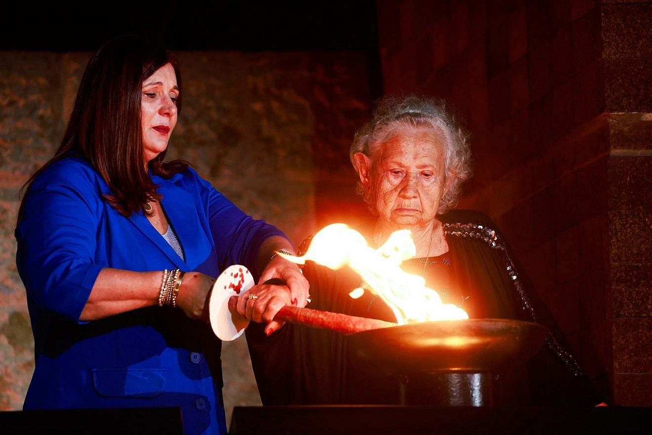 A Holocaust survivor and family member light a torch during a ceremony at Yad Vashem in Jerusalem, as Israel marks Holocaust Remembrance Day, April 17, 2023. Photo by Erik Marmor/Flash90.