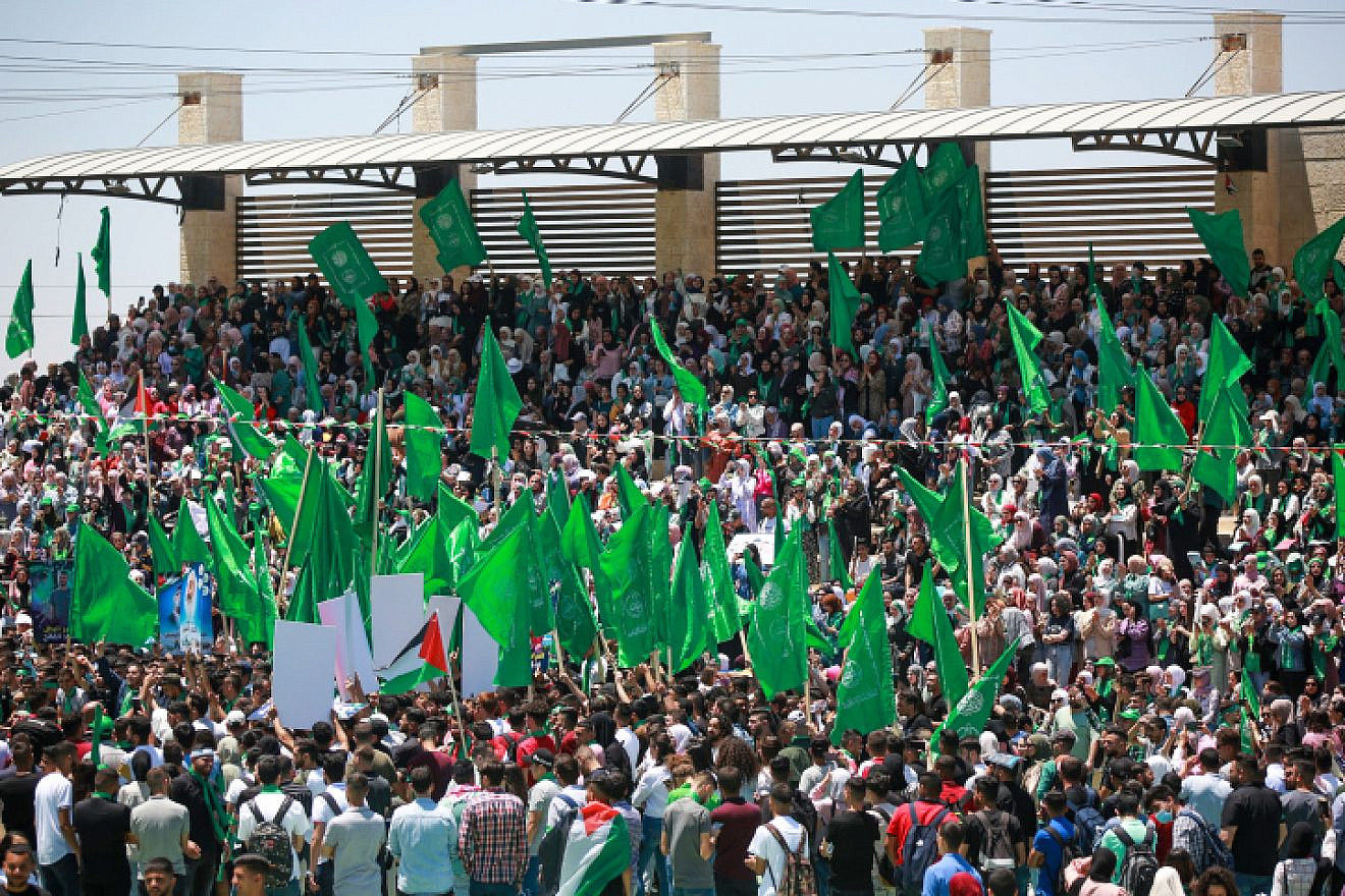 Hamas supporters wave the terrorist movement's flag during a student rally at Birzeit University, near Ramallah, May 19, 2022. Credit: Flash90.