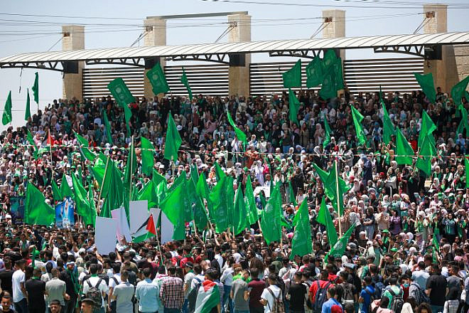 Hamas supporters wave the terrorist movement's flag during a student rally at Birzeit University, near Ramallah, May 19, 2022. Credit: Flash90.