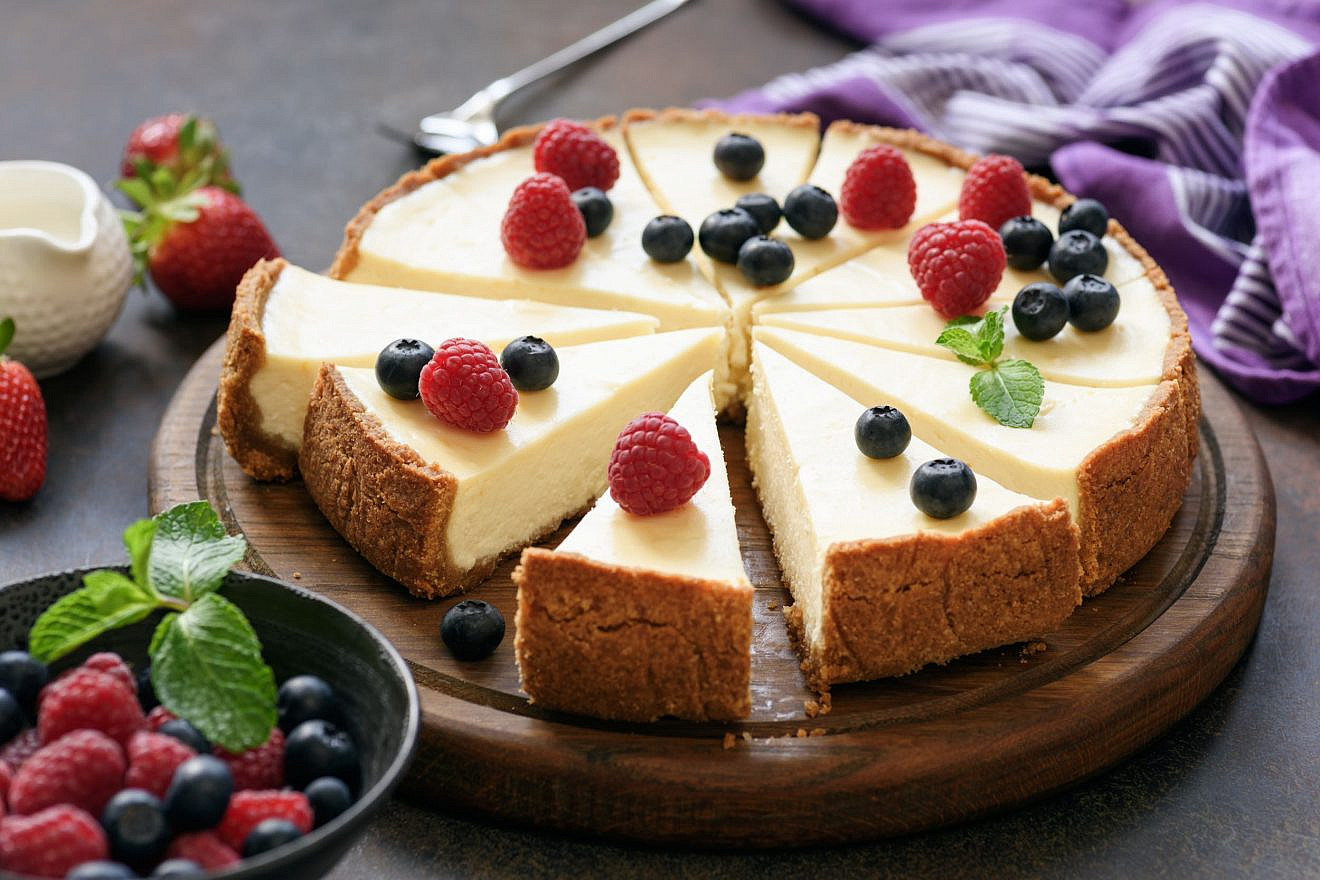 Classic plain New York Cheesecake sliced on wooden board. Photo: Vladislav Noseek/Shutterstock