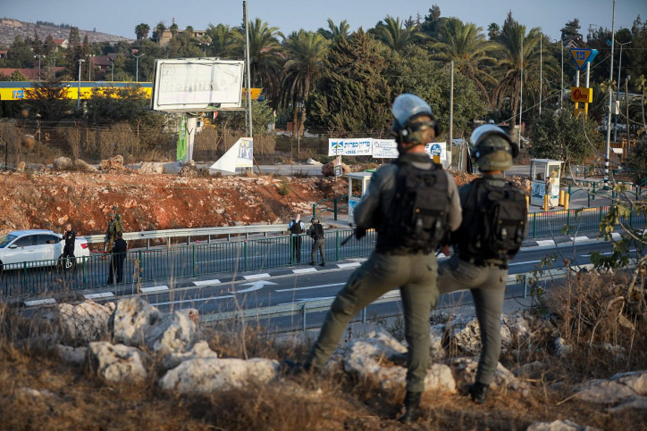 Israeli soldiers guard a bus station at the entrance to the Israeli community of Ofra, Oct. 4, 2022. Credit: Flash90.