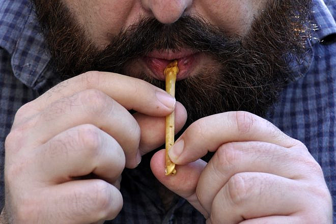Using a replica of one of the ancient whistles. Photo by Laurent Davin.
