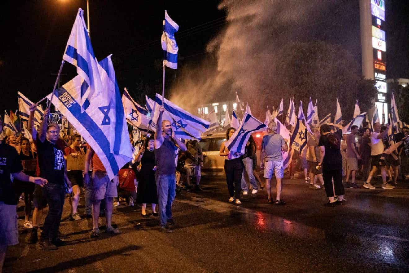 Anti-judicial reform demonstrators block a road and clash with police in Pardes Hanna-Karkur in the Haifa district ofn Israel, on July 11, 2023. Photo by Shir Torem/Flash90.